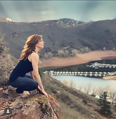 Ena Rodriguez O’Rourke meditating above a body of water in the mountains